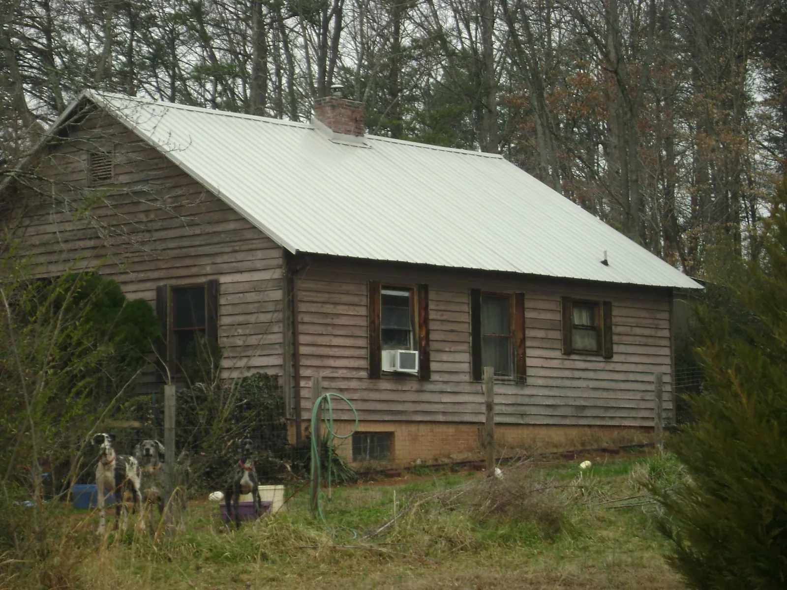 White metal roof on an old wood sided farmhouse, from a Metal Roof Installation job in Hustonville